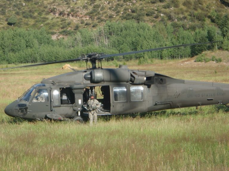 A Blackhawk lands in the field to pick up the team