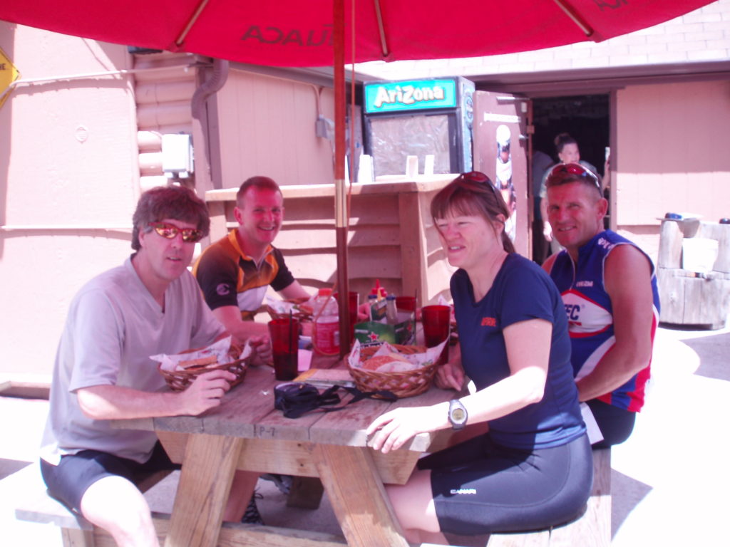 Team TravelCountry/Tango at a picnic table on a restaurant deck in Colorado during a training weekend