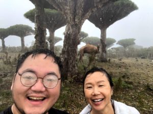 TK and Karen smiling in the rain during camel trek