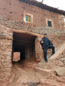 Rachid posing in front of Berber buildings